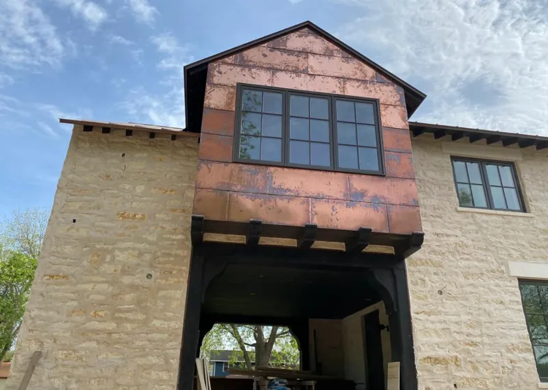 Copper metal panel facade on a stone building for Skylight Installation in Glenn Heights